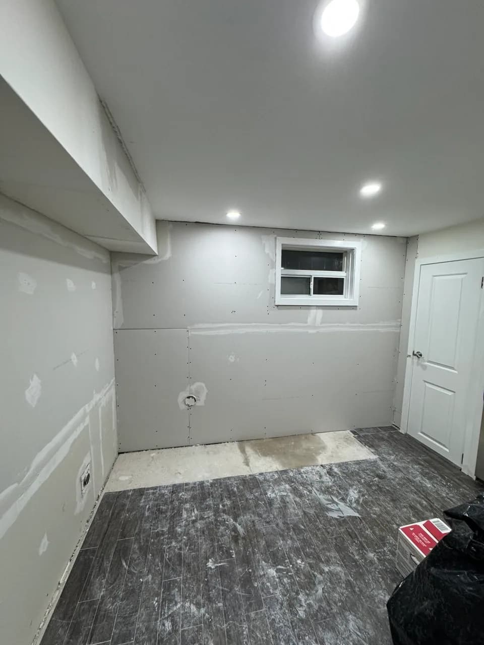 New drywall installed across a former kitchen wall in Etobicoke