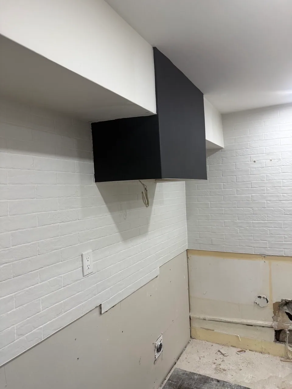 Remaining upper cabinet and former kitchen wall during an Etobicoke kitchen-to-room conversion
